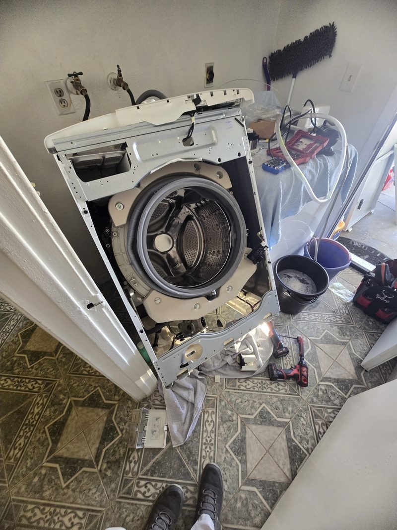 Front-load washer fully disassembled for drum and bearing service